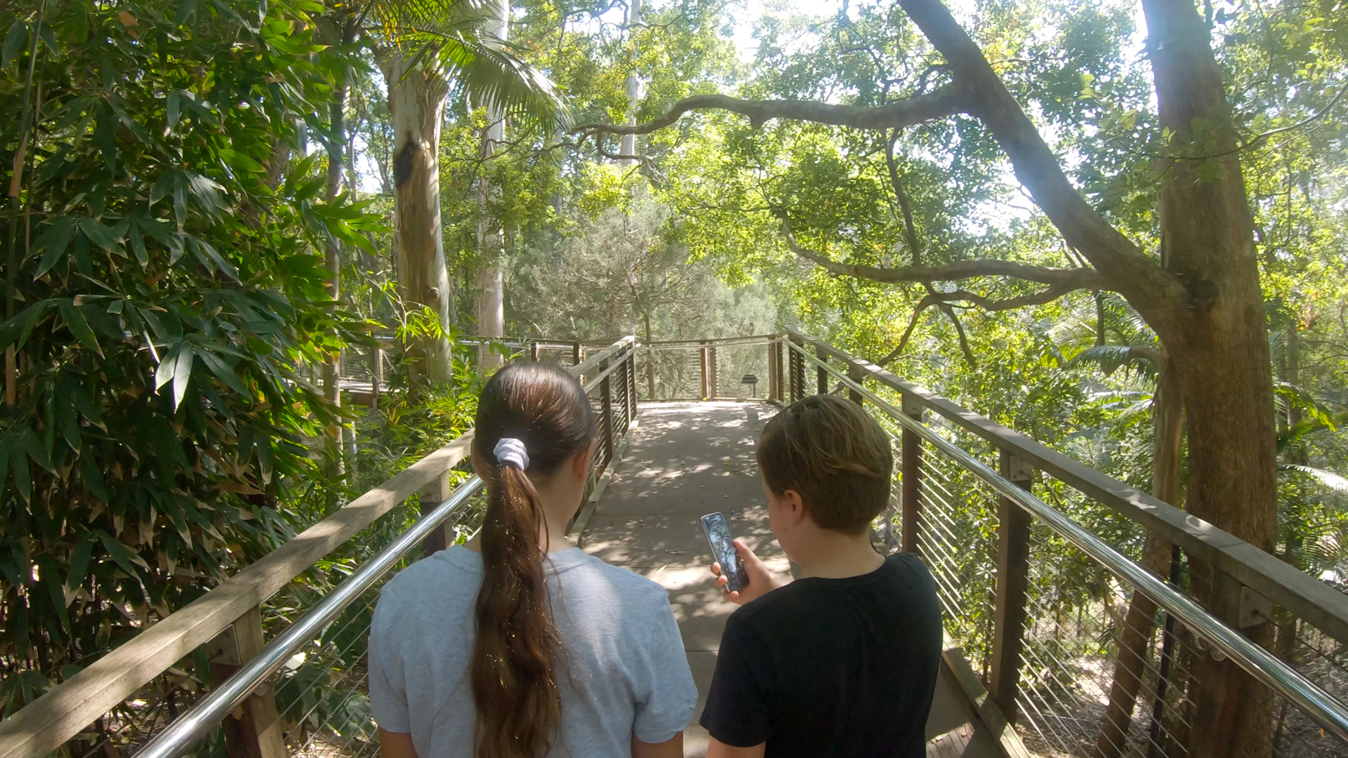 2 children walking through Lost Valley with game.jpg