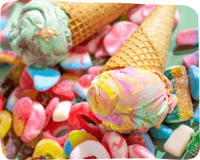 A close-up view of colorful ice cream topped with various candies, showcasing a delightful dessert experience
