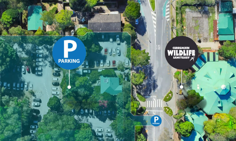 Aerial view of a parking lot featuring a prominent sign that reads