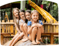 Four girls sitting on a rock at a water park