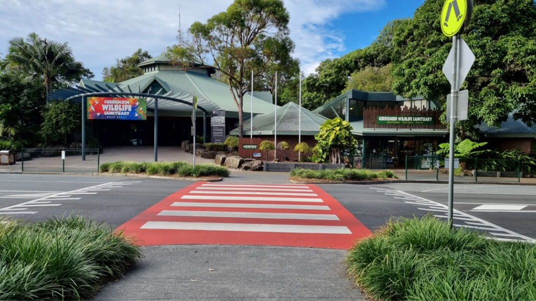 A crosswalk featuring a prominent sign indicating