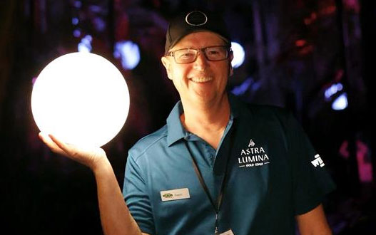 Astra lumina volunteer holds glowing orb