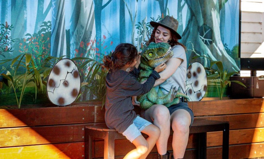 small child meets dinosaur baby puppet