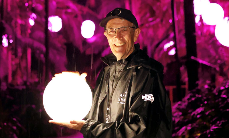 volunteer at astra lumina holds luminous orbs