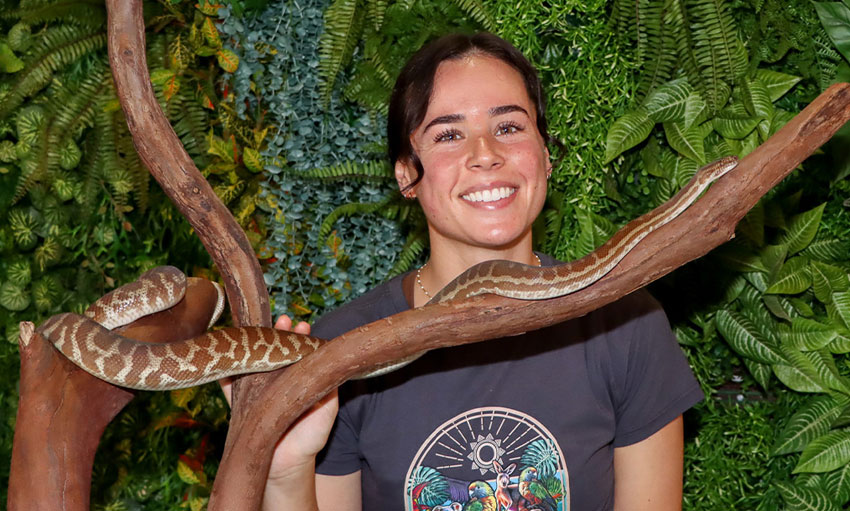 Photo of guest at Currumbin Sanctuary with snake in a tree