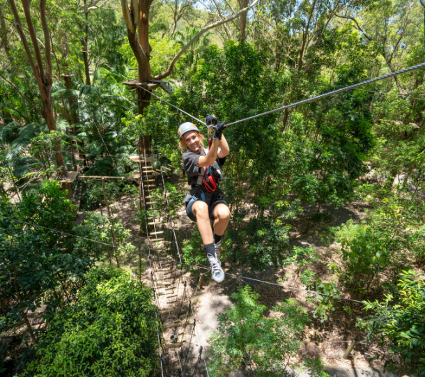 Girl on treetop challenge with helmet